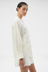 Profile view of model wearing the Oroton Long Sleeve Broderie Trim Shirt in SOFT CREAM and 100% heavyweight linen fabric for Women . IP:3