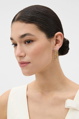 Profile view of model wearing the Oroton Eden Earrings in Clear/Worn Gold and Brass with sterling silver earring post for Women . IP:2