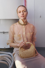 Profile view of model wearing the Oroton Clara Straw Mini Bag in Natural and Woven straw material for Women . IP:8