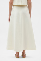 Profile view of model wearing the Oroton Bow Detail Skirt in Soft Cream and 100% heavyweight linen fabric for Women . IP:6
