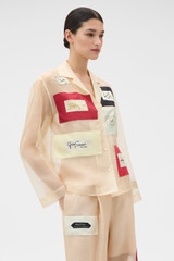 Profile view of model wearing the Oroton Patched Vintage Label Shirt in Nougat and 100% sheer silk organdy fabric for Women .