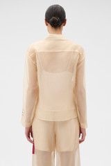 Profile view of model wearing the Oroton Patched Vintage Label Shirt in Nougat and 100% sheer silk organdy fabric for Women . IP:5