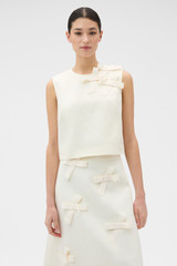 Profile view of model wearing the Oroton Bow Detail Shell in Soft Cream and 100% heavyweight linen fabric for Women . IP:2