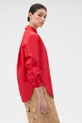 Profile view of model wearing the Oroton Satin Overshirt in Poppy and 85% polyester and 15% silk blend fabric for Women . IP:3