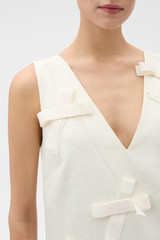 Profile view of model wearing the Oroton Bow Detail Shift Dress in Soft Cream and 100% linen fabric for Women . IP:4