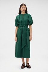 Profile view of model wearing the Oroton Grace Popover Dress in Helm Green and 100% cotton poplin fabric for Women . IP:2
