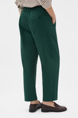 Profile view of model wearing the Oroton Arlo Carpenter Chino in Helm Green and 100% cotton fabric for Women .