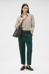 Profile view of model wearing the Oroton Arlo Carpenter Chino in Helm Green and 100% cotton fabric for Women . IP:6