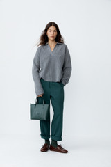 Profile view of model wearing the Oroton Arlo Carpenter Chino in Helm Green and 100% cotton fabric for Women . IP:9