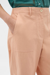Profile view of model wearing the Oroton Curved Leg Pant in Apple Peach and 100% cotton fabric for Women . IP:4