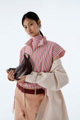 Profile view of model wearing the Oroton Funnel Neck Blouse in Cerise and 100% yarn dyed cotton fabric for Women . IP:8