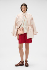Profile view of model wearing the Oroton Elastic Back Short in Cerise and 100% cotton twill fabric for Women . IP:6