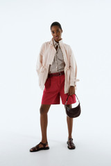 Profile view of model wearing the Oroton Elastic Back Short in Cerise and 100% cotton twill fabric for Women . IP:8
