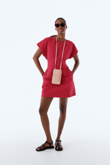 Profile view of model wearing the Oroton Stitch Detail Mini Dress in Cerise and 100% cotton canvas fabric for Women . IP:8
