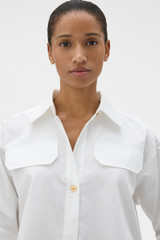 Profile view of model wearing the Oroton Button Detail Poplin Shirt in White and 100% cotton poplin fabric for Women .