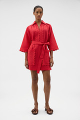 Profile view of model wearing the Oroton Handkerchief Tunic Dress in Ribbon Red and 100% mid-weight linen fabric for Women . IP:2