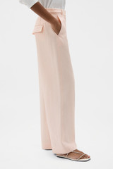 Profile view of model wearing the Oroton Flat Front Pant in Nougat and 100% heavy linen fabric for Women . IP:3