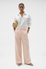 Profile view of model wearing the Oroton Flat Front Pant in Nougat and 100% heavy linen fabric for Women . IP:6