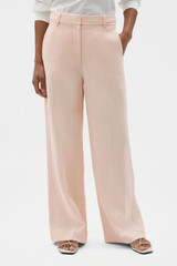 Profile view of model wearing the Oroton Flat Front Pant in Nougat and 100% heavy linen fabric for Women .