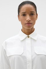 Profile view of model wearing the Oroton Button Detail Shirt Dress in White and 100% cotton poplin fabric for Women .