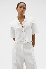 Profile view of model wearing the Oroton Handkerchief Camp Shirt in Antique White and 100% mid-weight linen fabric for Women . IP:2