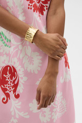 Profile view of model wearing the Oroton Coral Wide Cuff in Worn Gold and Brass base for Women . IP:2