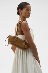 Profile view of model wearing the Oroton Breeze Suede Baguette in Dark Teak and Premium suede leather for Women . IP:2