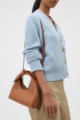 Profile view of model wearing the Oroton Myrtle Mini Bag in Cognac and Premium smooth leather for Women . IP:2