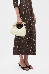 Profile view of model wearing the Oroton Myrtle Mini Bag in Vanilla Bean and Premium smooth leather for Women . IP:2