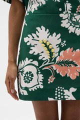 Profile view of model wearing the Oroton Cabana Floral Mini Skirt in Helm Green and 100% silk dupion fabric for Women . IP:4