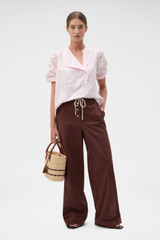 Profile view of model wearing the Oroton Weekend Pull On Pant in Milk Chocolate and 100% cotton fabric for Women . IP:6