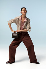 Profile view of model wearing the Oroton Weekend Pull On Pant in Milk Chocolate and 100% cotton fabric for Women . IP:8