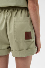 Profile view of model wearing the Oroton Weekend Short in Soft Sage and 100% cotton fabric for Women . IP:4