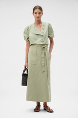 Profile view of model wearing the Oroton Snap Detail Skirt in Soft Sage and 100% cotton fabric for Women . IP:6