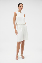 Profile view of model wearing the Oroton Tassel Lace Short in White and 45% viscose, 30% rayon, and 25% linen blend fabric for Women . IP:3