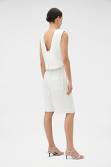 Profile view of model wearing the Oroton Tassel Lace Short in White and 45% viscose, 30% rayon, and 25% linen blend fabric for Women . IP:5