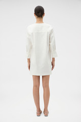 Profile view of model wearing the Oroton Embellished Short Tunic Dress in Antique White and 100% cotton poplin material for Women . IP:5