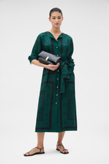 Profile view of model wearing the Oroton Spot Scarf Print Column Dress in HELM GREEN and 100% silk twill fabric for Women . IP:6