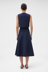 Profile view of model wearing the Oroton Zip Midi Skirt in North Sea and 100% cotton fabric for Women . IP:5