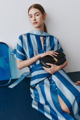 Profile view of model wearing the Oroton Slub Silk Stripe Column Dress in Azure Blue and 100% silk fabric for Women . IP:11