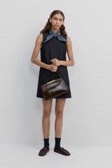 Profile view of model wearing the Oroton Denim Dress in Dark Denim and 100% cotton fabric for Women . IP:8