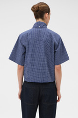 Profile view of model wearing the Oroton Check Tie Neck Shirt in North Sea and 100% cotton fabric for Women . IP:5