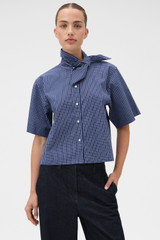 Profile view of model wearing the Oroton Check Tie Neck Shirt in North Sea and 100% cotton fabric for Women . IP:2