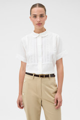Profile view of model wearing the Oroton Delicate Short Sleeve Shirt in Antique White and 55% linen and 45% cotton blend fabric for Women . IP:2