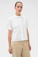 Profile view of model wearing the Oroton Delicate Short Sleeve Shirt in Antique White and 55% linen and 45% cotton blend fabric for Women . IP:3