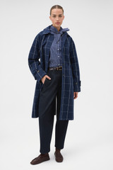 Profile view of model wearing the Oroton Sunday Check Mac in North Sea and 100% cotton fabric for Women . IP:6