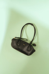 Profile view of model wearing the Oroton Breeze Texture Baguette in Black Snake and Premium embossed leather for Women . IP:8