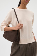 Profile view of model wearing the Oroton Cali Suede Shoulder Bag in Dark Chocolate and Premium cow suede leather for Women . IP:3
