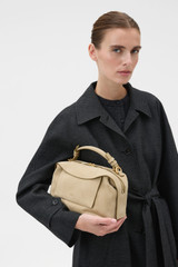 Profile view of model wearing the Oroton Mica Suede Bowler in Caper and Premium suede leather for Women . IP:3
