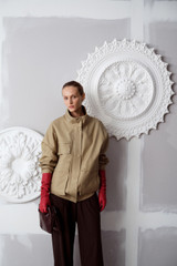 Profile view of model wearing the Oroton Utility Parka in Haystack and 100% cotton fabric for Women .